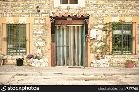 The facade of the Spanish house, decorated with dry and live plants. Vintage style.