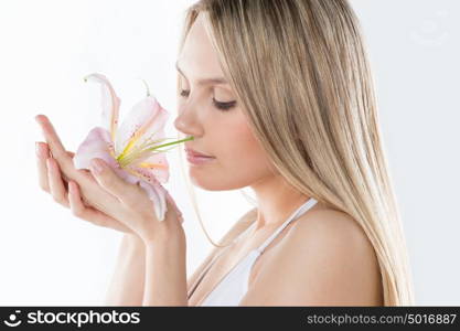 The face of a beautiful girl with a fresh flower lily