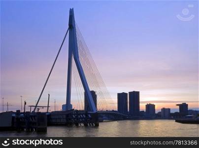 The famous Erasmus Suspension bridge with the Rotterdam skyline in the background against the colours of the setting sun