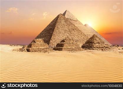 The famous Giza Pyramids in the desert at sunset, Egypt.. The famous Giza Pyramids in the desert at sunset, Egypt