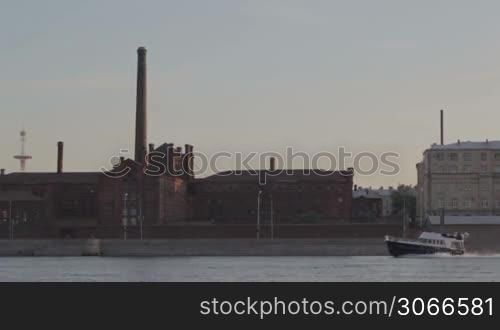 "The famous "Kresti" prison in Saint Petersburg. Arsenalnaya quay. Motor boat passes by."