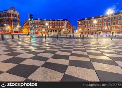The famous Massena Square in the night lights at dawn. Nice. France. Cote d'Azur.. Nice. View of Massena Square in night lighting.