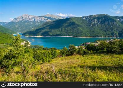 The famous Piva river canyon with its fantastic reservoir Piva Lake (Pivsko Jezero) and Pluzine town summer view in Montenegro. Nature travel background.