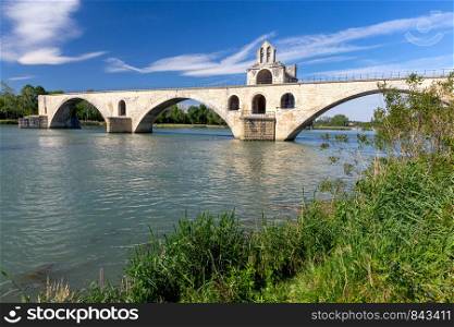 The famous St. Beneset Bridge over the Rhone River on a sunny day. Avignon. France. Provence.. Avignon. Bridge of St. Benezet over the Rhone River.