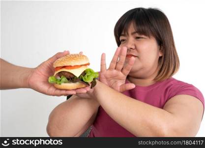 The fat Asian healthy woman Refuse to eat the burger. Concept of healthcare and nutritious food