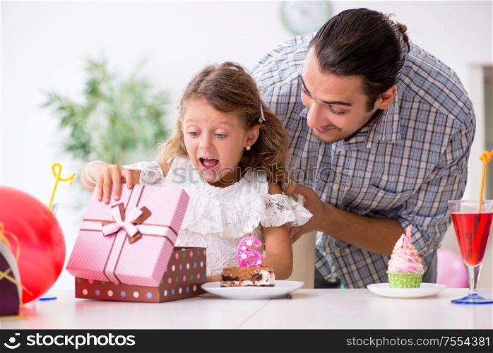 The father celebrating birthday with his daughter. Father celebrating birthday with his daughter