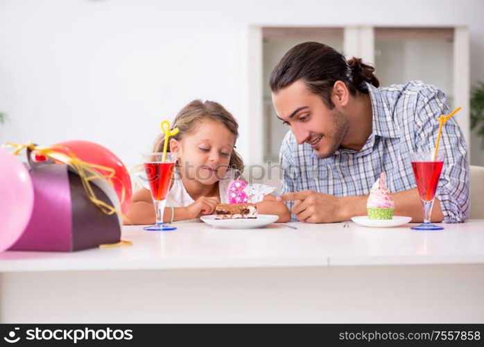 The father celebrating birthday with his daughter. Father celebrating birthday with his daughter