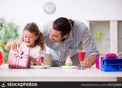 The father celebrating birthday with his daughter. Father celebrating birthday with his daughter