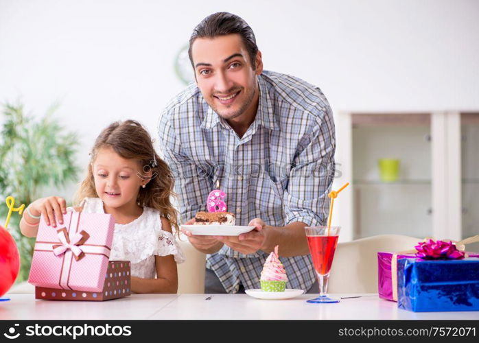 The father celebrating birthday with his daughter. Father celebrating birthday with his daughter