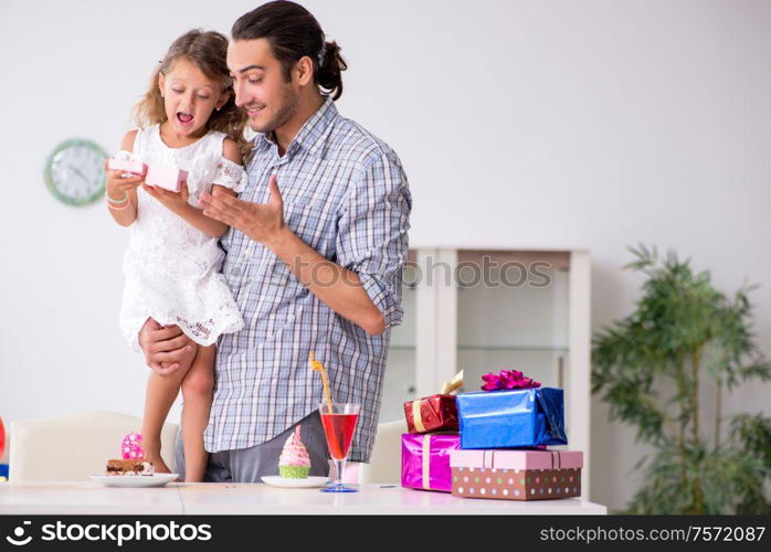 The father celebrating birthday with his daughter. Father celebrating birthday with his daughter