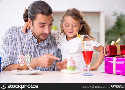 The father celebrating birthday with his daughter. Father celebrating birthday with his daughter