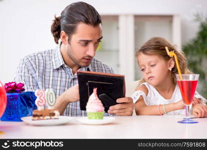 The father celebrating birthday with his daughter. Father celebrating birthday with his daughter