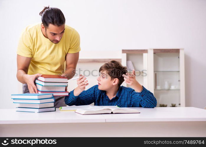 The father helping his son to prepare for school. Father helping his son to prepare for school