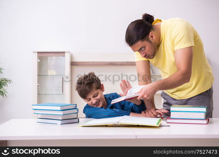 The father helping his son to prepare for school. Father helping his son to prepare for school