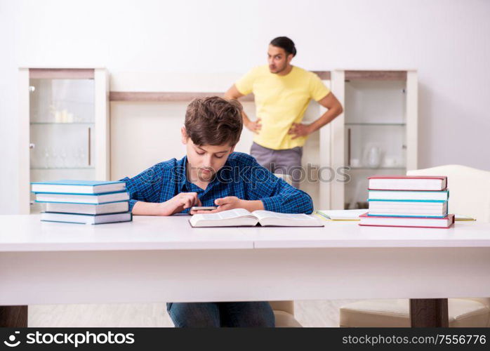 The father helping his son to prepare for school. Father helping his son to prepare for school