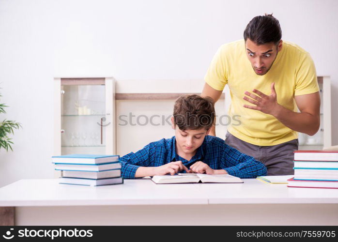 The father helping his son to prepare for school. Father helping his son to prepare for school