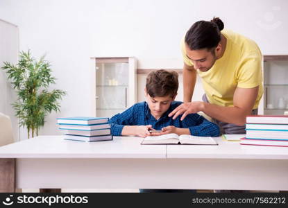 The father helping his son to prepare for school. Father helping his son to prepare for school