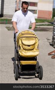 The father with a baby carriage