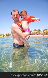 The father with a daughter about a beach