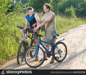 The father with the son on bicycles