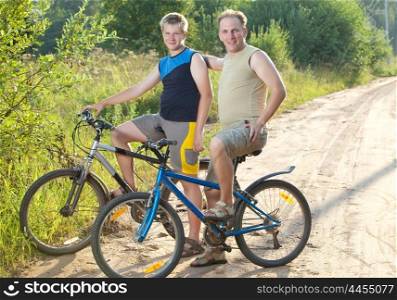 The father with the son on bicycles