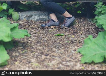 The feet of a young woman in a forest