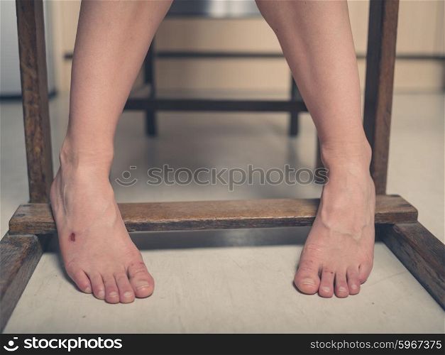 The feet of a young woman with a scab on one of them
