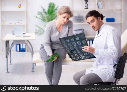 The female alcoholic visiting young male doctor . Female alcoholic visiting young male doctor