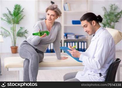 The female alcoholic visiting young male doctor. Female alcoholic visiting young male doctor
