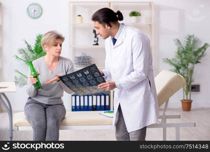 The female alcoholic visiting young male doctor. Female alcoholic visiting young male doctor