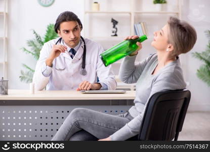 The female alcoholic visiting young male doctor. Female alcoholic visiting young male doctor