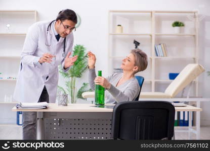 The female alcoholic visiting young male doctor. Female alcoholic visiting young male doctor