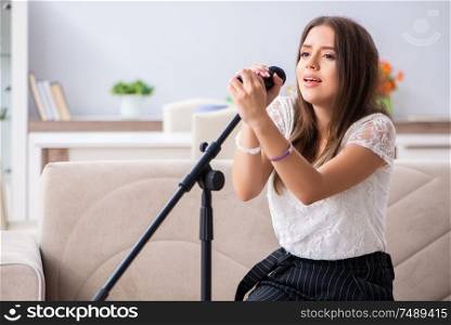 The female beautiful musician singing at home. Female beautiful musician singing at home