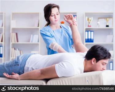 The female chiropractor doctor massaging male patient. Female chiropractor doctor massaging male patient