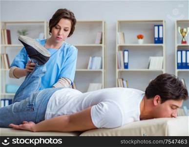The female chiropractor doctor massaging male patient. Female chiropractor doctor massaging male patient