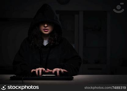 The female hacker hacking security firewall late in office . Female hacker hacking security firewall late in office