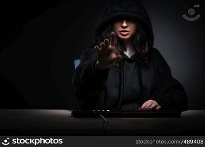 The female hacker hacking security firewall late in office. Female hacker hacking security firewall late in office