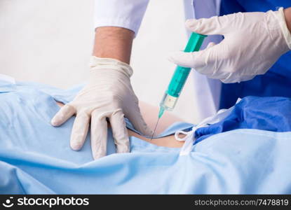 The female patient getting an injection in the clinic . Female patient getting an injection in the clinic