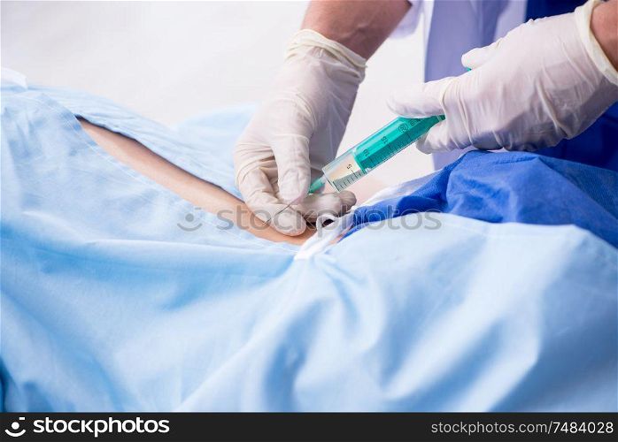 The female patient getting an injection in the clinic . Female patient getting an injection in the clinic