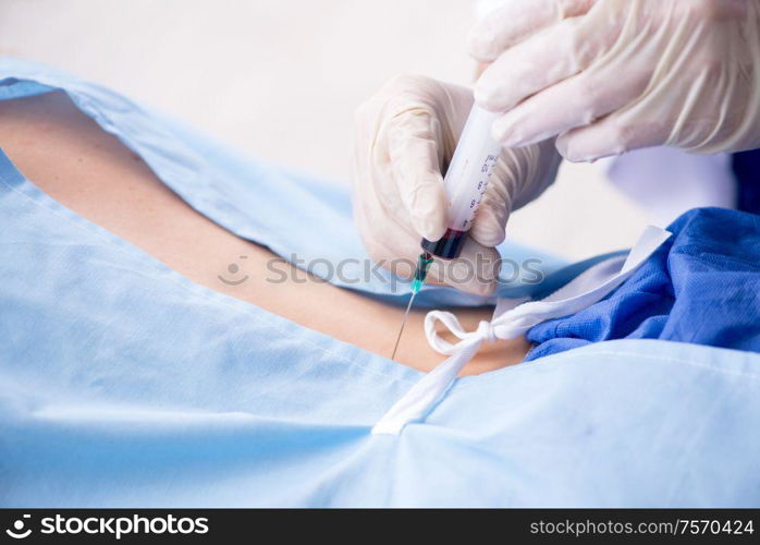 The female patient getting an injection in the clinic. Female patient getting an injection in the clinic