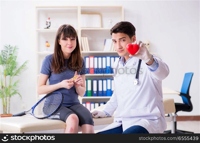 The female tennis player visiting male doctor for check-up. Female tennis player visiting male doctor for check-up