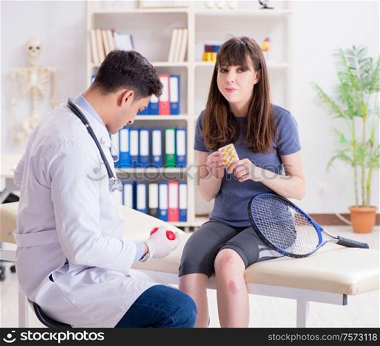 The female tennis player visiting male doctor for check-up. Female tennis player visiting male doctor for check-up