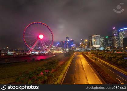 The ferris wheel, Hong Kong Observation Wheel, and amusement park for kids in holiday vacation and travel trip concept. Hong Kong City. Downtown and Victoria Harbour.
