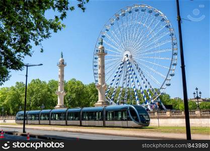 the ferris wheel in the city of Bordeaux in France with streetcar