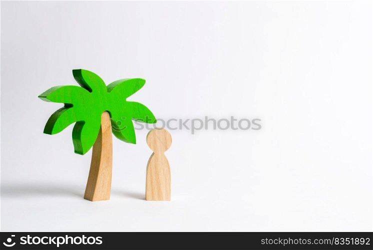 The figure of the person costs under a wooden palm tree on a white background. Vacation or trip. Stuck on a desert island. Personal space and moral rest. Harmony, balance in life, psychological health