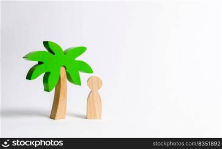 The figure of the person costs under a wooden palm tree on a white background. Vacation or trip. Stuck on a desert island. Personal space and moral rest. Harmony, balance in life, psychological health
