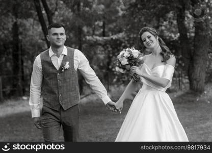 the first meeting of the bride and groom in wedding outfits in the park