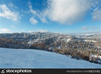 The first shadows of setting sun on winter mountain slopes with ski run (Skole Beskids, Lviv Oblast, Carpathians, Ukraine)