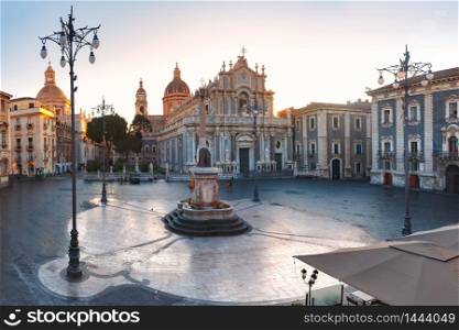 The first sunray on Piazza Duomo in Catania and the Cathedral of Santa Agatha and Liotru, symbol of Catania at sunrise, Sicily,. Catania Cathedral at sunrise, Sicily, Italy
