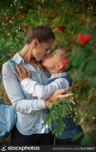 The first time in first class. The first time in first class: happy schoolboy with his mother going to the school in first time